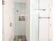 Modern shower with glass door, rainfall showerhead, decorative tile, and built-in shelf at 3235 Crestview Dr, Cumming, GA 30041