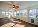 Bright sunroom with hardwood flooring, multiple windows, and ceiling fans at 3235 Crestview Dr, Cumming, GA 30041