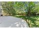 Backyard with concrete patio, green grass and trees at 4044 Ashentree Dr, Brookhaven, GA 30341