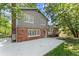 The home's backyard has a concrete patio, brick exterior, and well-maintained lawn at 4044 Ashentree Dr, Brookhaven, GA 30341