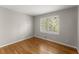 Inviting bedroom featuring a bright window, hardwood floors, and neutral paint at 4044 Ashentree Dr, Brookhaven, GA 30341