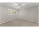 Bright bedroom featuring a large window with plantation shutters and neutral carpet at 4044 Ashentree Dr, Brookhaven, GA 30341