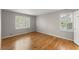 Sunlit bedroom with hardwood floors, plantation shutters, and a white door at 4044 Ashentree Dr, Brookhaven, GA 30341