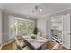 Bright dining room with a bay window, hardwood floors, and modern lighting fixtures at 4044 Ashentree Dr, Brookhaven, GA 30341