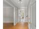 Light and airy foyer with hardwood floors, white trim, and a view into the adjacent kitchen with black and white floors at 4044 Ashentree Dr, Brookhaven, GA 30341