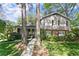 Charming two-story home featuring a brick and siding facade, lush landscaping, and a welcoming walkway to the front door at 4044 Ashentree Dr, Brookhaven, GA 30341