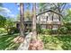 Charming two-story home featuring a brick and siding facade, lush landscaping, and a welcoming walkway to the front door at 4044 Ashentree Dr, Brookhaven, GA 30341