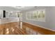 Open concept living room and kitchen, features hardwood floors, natural lighting, and backyard access at 4044 Ashentree Dr, Brookhaven, GA 30341