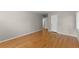 Empty room with hardwood floors, neutral walls, base trim, and a window with white shutters at 4044 Ashentree Dr, Brookhaven, GA 30341