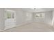 A versatile room with neutral carpet, ample natural light, and a unique Dutch door at 4044 Ashentree Dr, Brookhaven, GA 30341