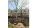 Multi-level townhomes with backyard decks and privacy fences nestled beneath a mature shade tree at 6433 Stone Way, Morrow, GA 30260
