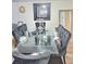 Dining room with glass table, black tufted chairs and mirrored accents at 6433 Stone Way, Morrow, GA 30260