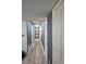 Hallway with light gray walls and wood-look vinyl flooring leading to a door at 6433 Stone Way, Morrow, GA 30260