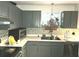 This home's kitchen is equipped with stainless steel appliances and grey cabinets at 6433 Stone Way, Morrow, GA 30260