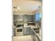 Kitchen featuring stainless steel appliances, grey cabinetry, and mosaic backsplash at 6433 Stone Way, Morrow, GA 30260