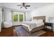 Bright main bedroom with hardwood floors, ceiling fan, large windows and seating at 756 Ormewood Se Ave, Atlanta, GA 30312