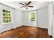 Sunlit bedroom features hardwood floors and classic white paint at 756 Ormewood Se Ave, Atlanta, GA 30312