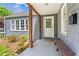 Inviting covered front porch with wood columns, a bench, and a view of the charming exterior at 756 Ormewood Se Ave, Atlanta, GA 30312