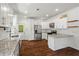 Bright and modern kitchen with stainless steel appliances, granite countertops, and sleek white cabinetry at 756 Ormewood Se Ave, Atlanta, GA 30312