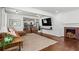 Spacious living room featuring hardwood floors, a fireplace, and an open layout to the kitchen at 756 Ormewood Se Ave, Atlanta, GA 30312