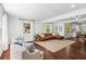 Bright and spacious living room with hardwood floors, large windows, and open access to the kitchen at 756 Ormewood Se Ave, Atlanta, GA 30312
