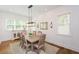 Bright dining room with large windows, a rustic table, and stylish accents, perfect for entertaining at 2235 Birchtree Way, Marietta, GA 30062