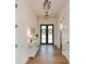 Inviting hallway with hardwood floors, elegant lighting, and a stylish console table at 2235 Birchtree Way, Marietta, GA 30062