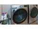 Modern laundry room features side by side washer and dryer and storage at 2235 Birchtree Way, Marietta, GA 30062