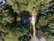 Aerial view of a home surrounded by mature trees, green lawn, and a long driveway at 2340 Bexford Vw, Cumming, GA 30041
