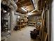 Unfinished basement with exposed ductwork and wooden shelving for storage at 2340 Bexford Vw, Cumming, GA 30041