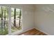 Walk-in closet with wood floors, adjustable shelving, and a large window offering natural light and outdoor views at 2340 Bexford Vw, Cumming, GA 30041