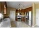 Well-lit kitchen featuring dark wood cabinets, stainless steel appliances, backsplash, and tiled flooring at 2340 Bexford Vw, Cumming, GA 30041