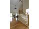 Inviting living room boasting hardwood floors, vaulted ceiling, and staircase with decorative iron spindles at 2340 Bexford Vw, Cumming, GA 30041