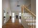 Inviting living room boasting hardwood floors, vaulted ceiling, and staircase with decorative iron spindles at 2340 Bexford Vw, Cumming, GA 30041