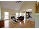 Spacious living room with hardwood floors, fireplace, vaulted ceilings, and view to kitchen at 2340 Bexford Vw, Cumming, GA 30041