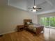 Spacious main bedroom featuring hardwood floors, a tray ceiling with ceiling fan, and natural light at 2340 Bexford Vw, Cumming, GA 30041