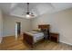 Bright main bedroom featuring hardwood floors, a tray ceiling with ceiling fan, and natural light at 2340 Bexford Vw, Cumming, GA 30041