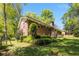Charming backyard featuring lush green lawn and manicured hedges that surround the brick house at 2927 Ponderosa Cir, Decatur, GA 30033