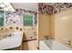 Bathroom featuring retro floral wallpaper, vintage tile, and neutral-colored fixtures at 2927 Ponderosa Cir, Decatur, GA 30033