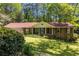Attractive brick home with a well-kept lawn, featuring an attached garage and charming front porch at 2927 Ponderosa Cir, Decatur, GA 30033