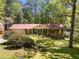 Charming brick home featuring lush landscaping, green shutters, and an attached two-car garage at 2927 Ponderosa Cir, Decatur, GA 30033