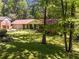 Traditional-style brick home with a well-manicured lawn and mature trees creating a serene setting at 2927 Ponderosa Cir, Decatur, GA 30033