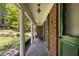 Inviting covered porch featuring classic white columns, brick accents, and a cozy bench at 2927 Ponderosa Cir, Decatur, GA 30033