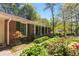 Charming covered front porch with white columns, green shutters, and manicured flower beds at 2927 Ponderosa Cir, Decatur, GA 30033