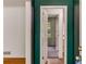 Hallway view featuring hardwood floors and a door opening into a sunlit room at 2927 Ponderosa Cir, Decatur, GA 30033