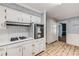 Classic kitchen with stainless steel oven, cooktop, white cabinets, and tile flooring at 2927 Ponderosa Cir, Decatur, GA 30033