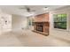 Open living room with a brick fireplace, large windows, and access to the side of the home at 2927 Ponderosa Cir, Decatur, GA 30033