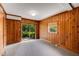 Living room with wood paneling, sliding glass door, and natural light at 2927 Ponderosa Cir, Decatur, GA 30033