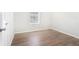 Bedroom with hardwood floors, white walls, and a window for natural light at 3448 Great Meadows Ct, Lithonia, GA 30038