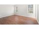 Spacious bedroom with two windows and hardwood floors, providing ample natural light at 3448 Great Meadows Ct, Lithonia, GA 30038